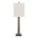A table lamp with an antique brass rectangular base and a white linen rectangular shade.