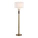 A gold floor lamp with a white linen drum shade.