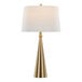 A gold table lamp with a conical base and a white linen drum shade.