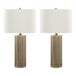 A pair of antique brass table lamps with white linen drum shades.
