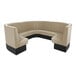 A large, curved beige booth with a high back and black base, designed for seating in a commercial or restaurant setting.