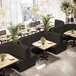 A long, curved ebony booth with channel tufting and a 42-inch high back, designed for restaurant seating.