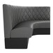A graphite-colored, diamond-tufted, quarter-circle corner booth with a high backrest.