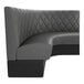 A graphite-colored, diamond-tufted, quarter-circle corner booth with a high backrest.