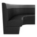 A curved, black and graphite upholstered booth with a high backrest and a half-circle design.