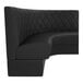 A black, diamond-tufted, half-circle booth with high backrest and cushioned seating.