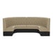 A large, half-circle booth with diamond tufted upholstery in a fawn color and a black base.