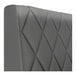 A graphite-colored, diamond-tufted upholstered booth backrest with a smooth, modern finish.