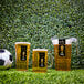 A set of FIFA World Cup 2026 branded plastic pint glasses and a pitcher filled with beer, displayed on grass next to a soccer ball.