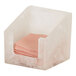 A white cloud-patterned square resin napkin holder containing pink napkins.