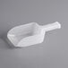 A white plastic scoop with a handle, typically used for dispensing ice or dry goods.