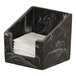 A black swirl square resin napkin holder containing white napkins.