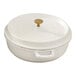 A white non-stick round casserole dish with a lid and a gold knob handle.