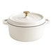 A white round non-stick casserole dish with a lid and gold knob handle.