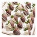 A tray of strawberries dipped in white and milk chocolate, drizzled with contrasting chocolate, some on sticks.