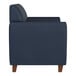 A navy blue loveseat with wooden feet and a boxy, modern design.