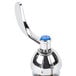 A chrome T&S deck-mount faucet with blue wrist action handles.