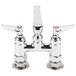 A T&S chrome deck mount faucet with two handles and two faucets.