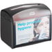 A black tabletop interfold napkin dispenser with a clear front panel displaying a promotional message.
