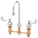 A chrome T&S deck mount faucet with two wrist action handles.