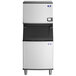 A commercial Manitowoc water-cooled ice machine with a large storage bin.