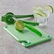 A Saf-T-Grip cutting board with lime wedges and a knife.