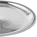 A Vollrath stainless steel round serving tray with a design on it.