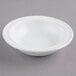 A white GET SuperMel bowl on a gray surface.