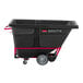 A black Rubbermaid Brute tilt truck with red wheels.