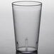 A clear plastic Carlisle tumbler with a black rim.