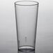 A Carlisle clear plastic tumbler on a table.