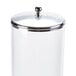 A white container with a metal lid and a silver handle.