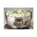 A Bon Chef triple wall bowl filled with cucumbers on a counter in a salad bar.