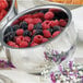 A Bon Chef double wall bowl filled with berries on a table.