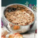 A Bon Chef angled double wall bowl filled with cereal and fruit on a table.
