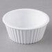 A white fluted Carlisle ramekin on a gray surface.