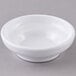 A white Carlisle salsa bowl on a gray surface.