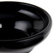 A close up of a black Carlisle salsa bowl.