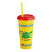A yellow "We Squeeze to Please" plastic souvenir cup with a straw and lid.