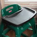 A black Rubbermaid high chair tray on a green high chair.