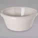 A Carlisle bone white plastic ramekin on a white surface.