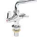 A chrome Equip by T&S deck-mounted faucet with lever handles and a swing spout.
