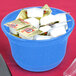 A Tablecraft blue speckle cast aluminum bowl on a counter with white yogurt packets in it.