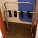 A metal CSL high back luggage rack with black straps on it.