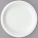 A Creative Converting white paper plate on a gray surface.