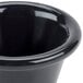 A close-up of a black Carlisle plastic ramekin.