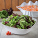 A white Carlisle flared melamine bowl filled with salad and shrimp.