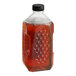 A close-up of a 5 lb. jar of Dutch Gold Clover Honey with a black cap.