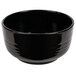 A black Tablecraft cast aluminum fruit bowl with wavy lines.