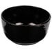 A black Tablecraft cast aluminum fruit bowl with a curved edge.